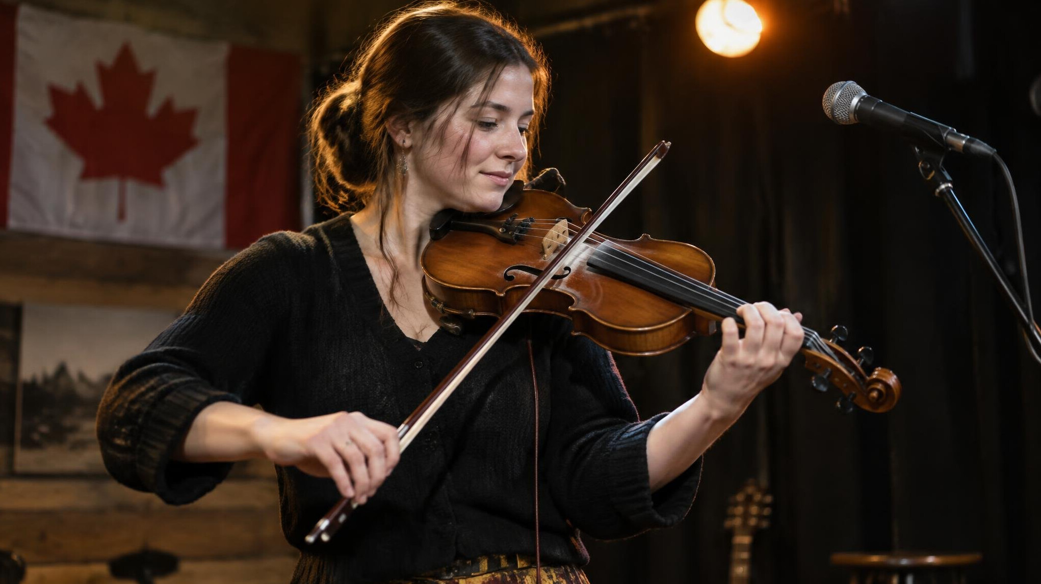 Musician performing with a violin in a small venue