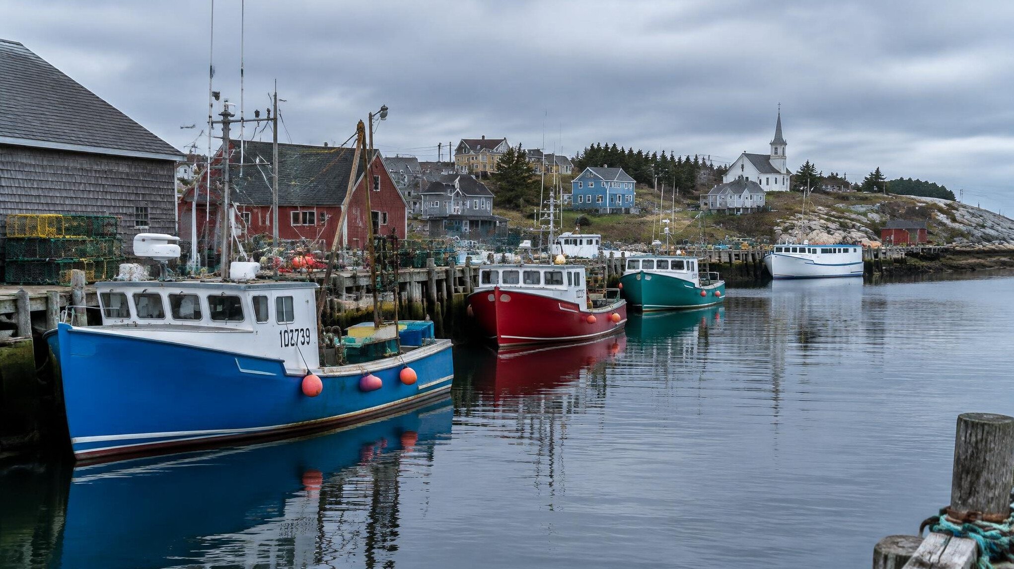 Fishing boats docked in a small Nova Scotia harbor town